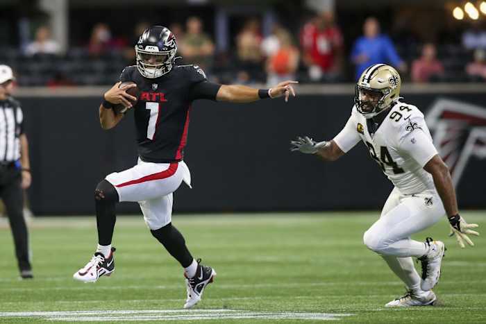 Sep 11, 2022; Atlanta Falcons quarterback Marcus Mariota (1) runs past New Orleans Saints defensive end Cameron Jordan (94). Mandatory Credit: Brett Davis-USA TODAY Sports